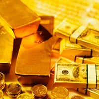 Close-up of a stack of gold bars and one hundred dollar bills and one euro coins