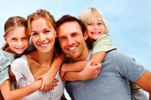 Portrait of a happy mature man and woman carrying kids on back