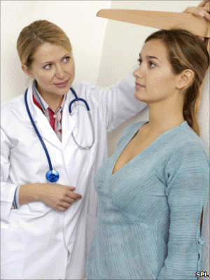 7298_woman-having-her-height-measured
