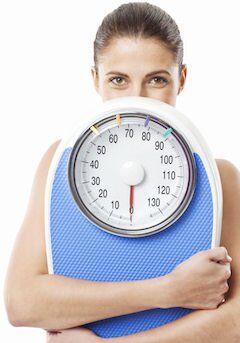 8860_happy-brunette-holding-scale